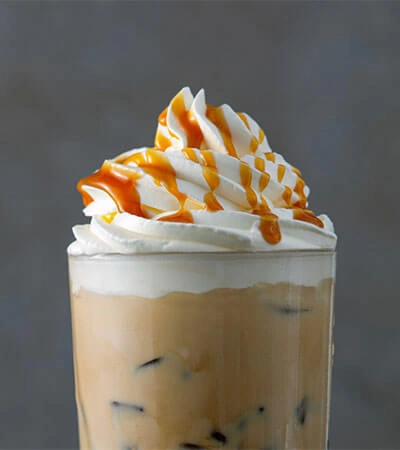 Complete Collagen Plus stirred into a caramel latte